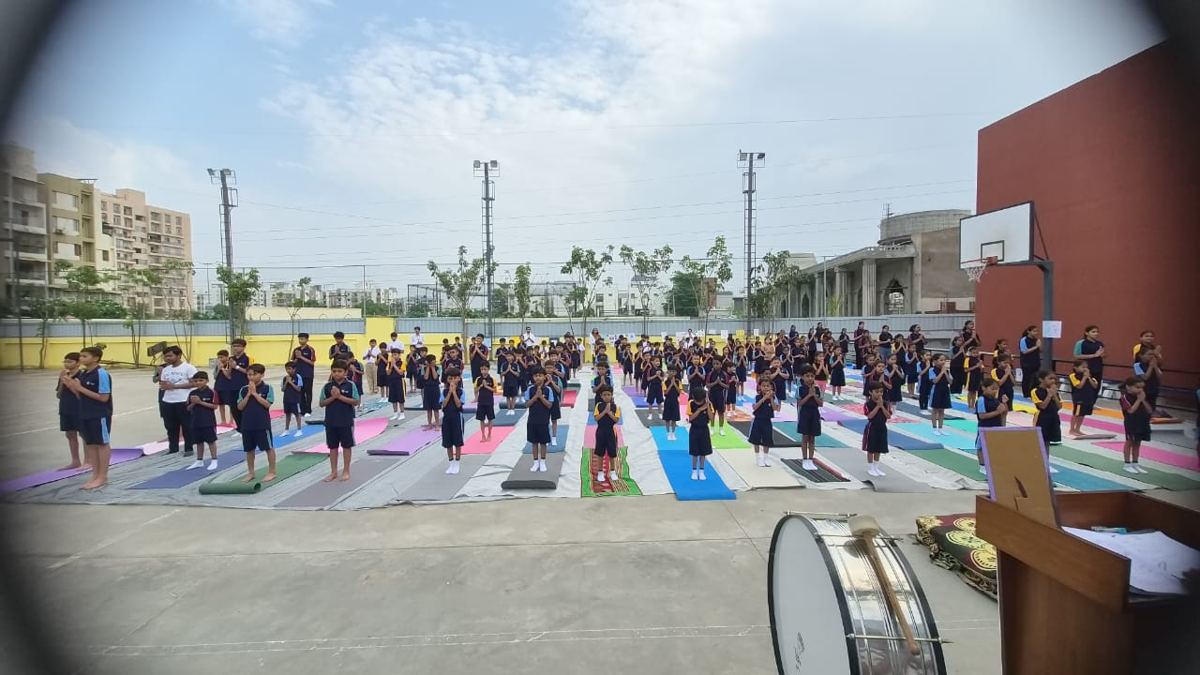 The whole school doing yoga together on mats in the school ground