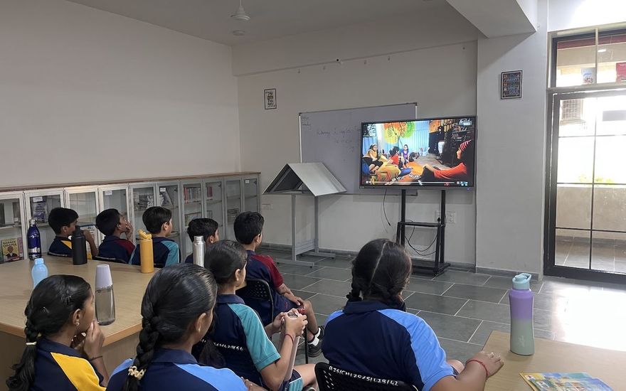 Students watching a lesson on the smart screen in a bright classroom