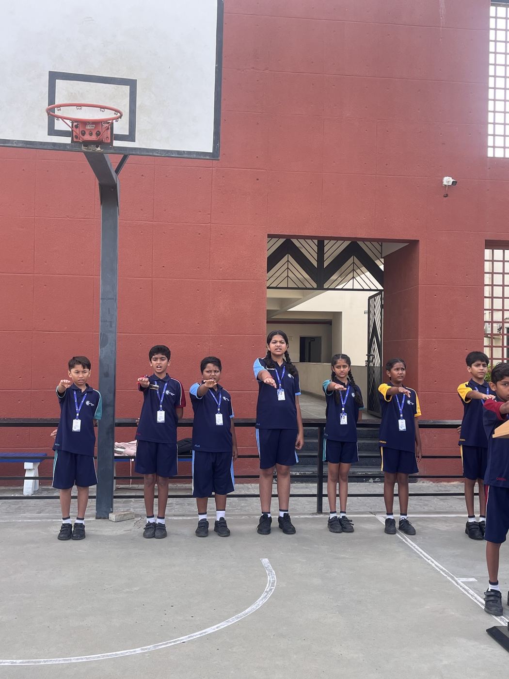 AARK students standing in line with folded hands at morning assembly