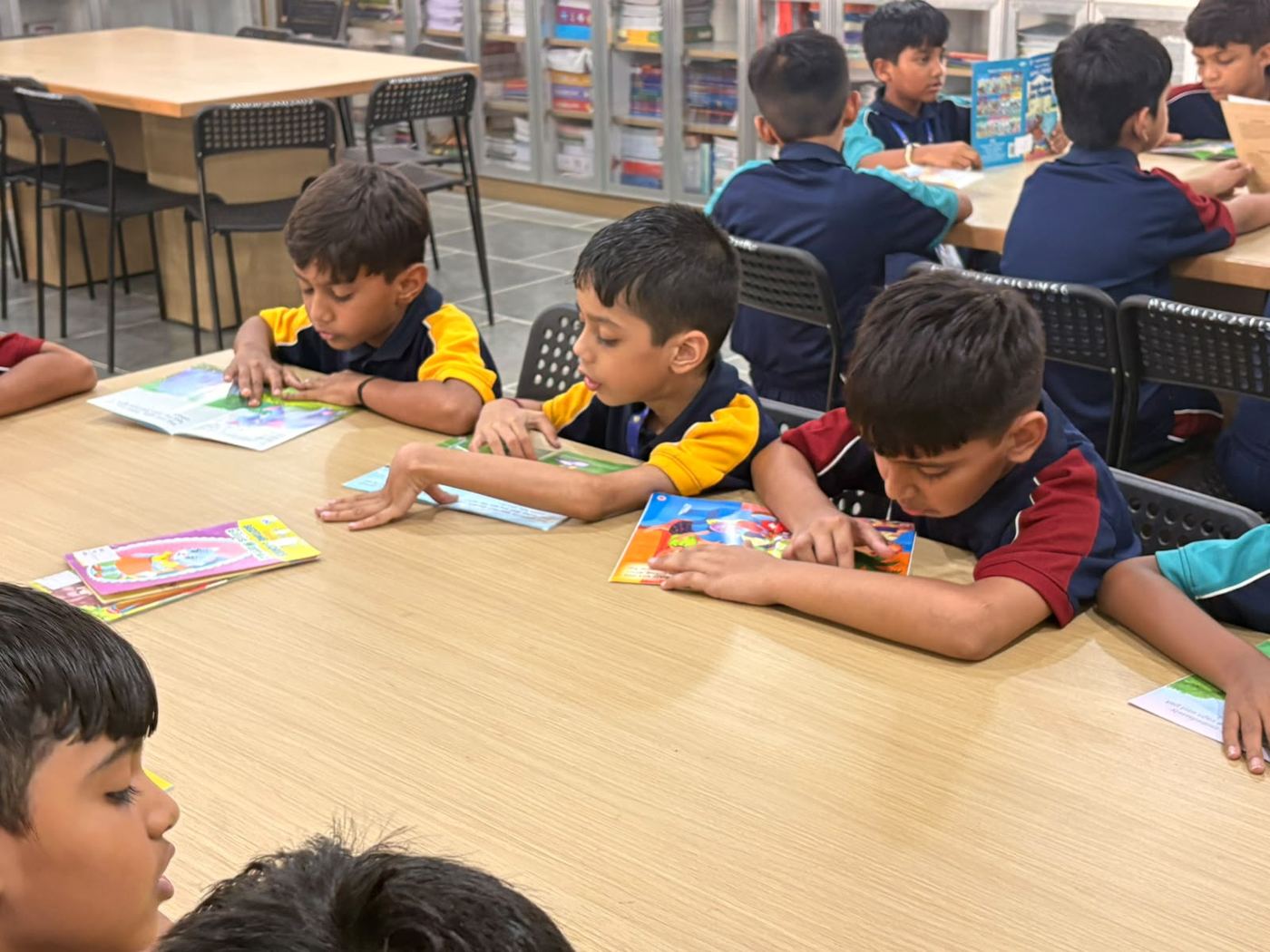 AARK students reading at a library table