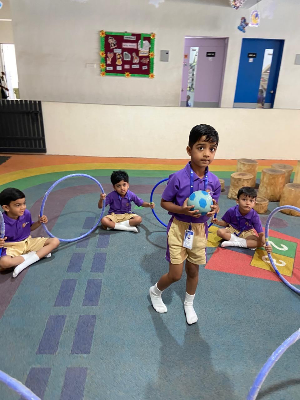 A child playing with hoops in the indoor play area